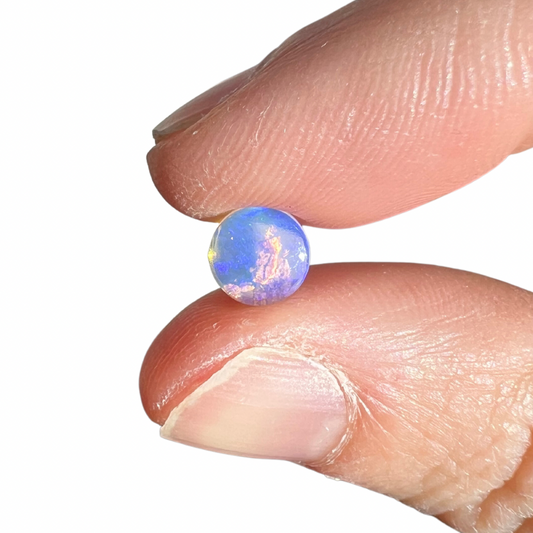 0.78 Ct round purple wood replacement opal